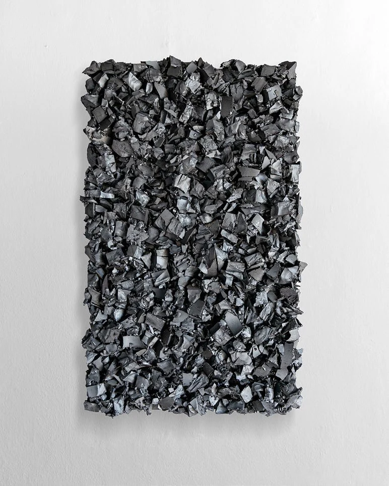 A vertical wall object made from crushed ferrite magnet and iron