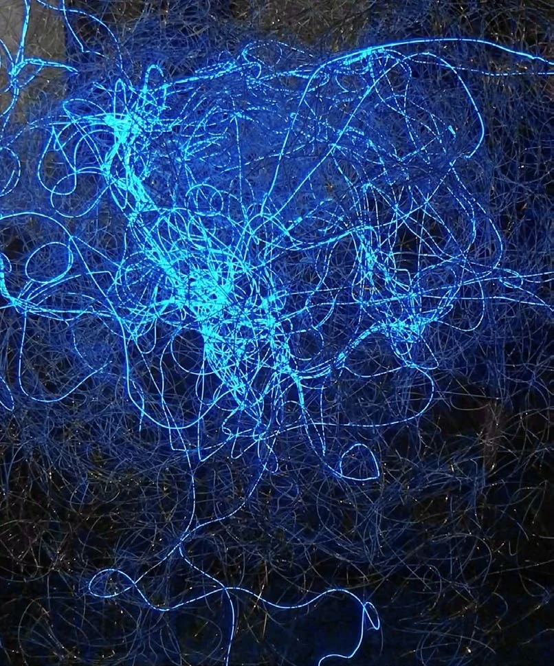 Close view of tangled blue light lines in The Human Connection