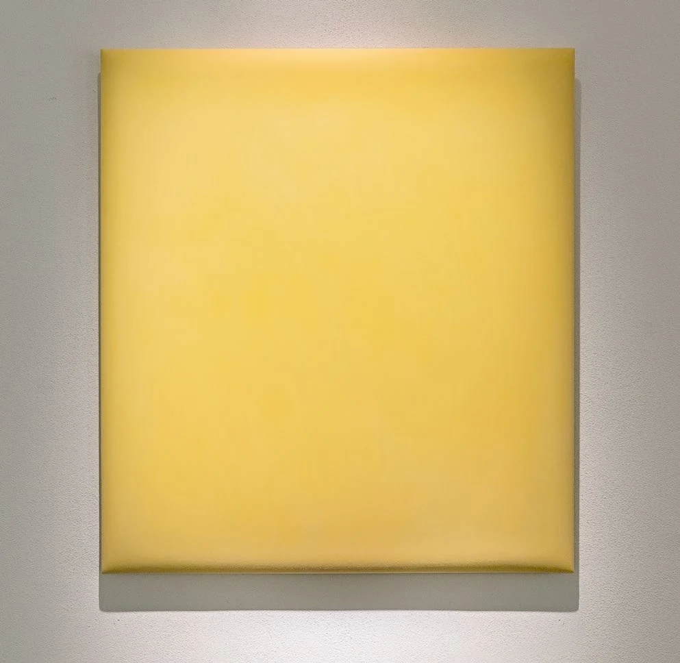 A softly glowing yellow high-density polyethylene wall work