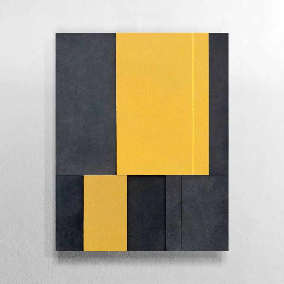 A wall relief of yellow and dark grey high-density polyethylene panels with aluminium