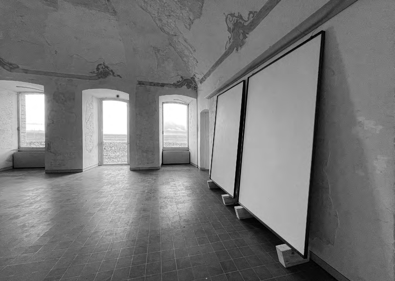 Large pale works from the 2% cycle leaning within the historic rooms of the Fortezza del Priamàr